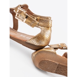 Golden sandals in the style of Japanese with buckles 2