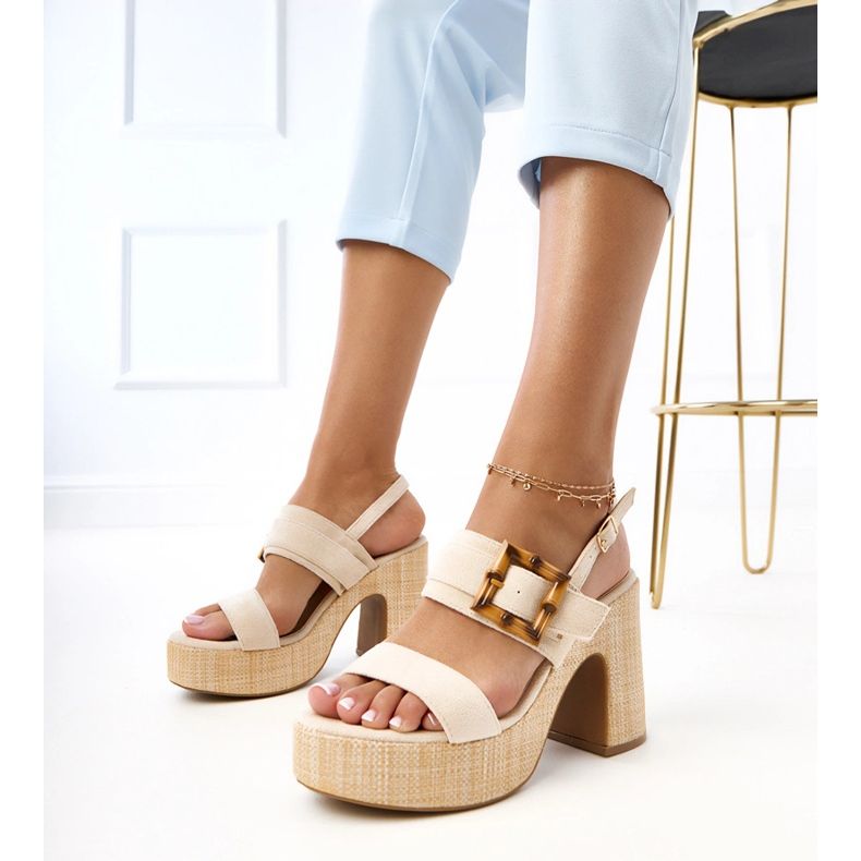 Beige sandals on the post decorated with Elevira clamp 1 Beige sandals on the post decorated with Elevira clamp 1