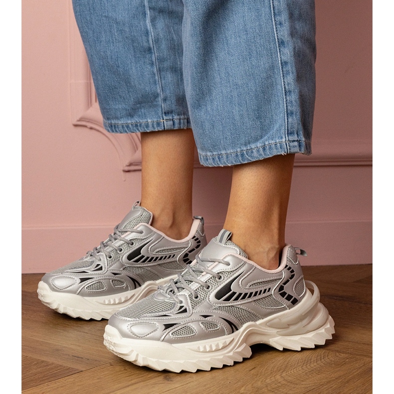 Silver sports sneakers on a stylish sole 1
