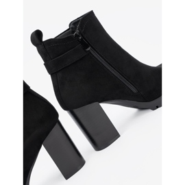 Shelvt Black boots on the post with a decorative clamp 1