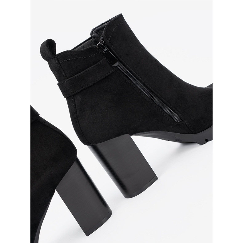 Shelvt Black boots on the post with a decorative clamp 1