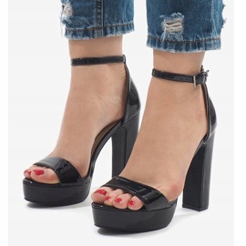 Black sandals on a varnished post 82985-7 1