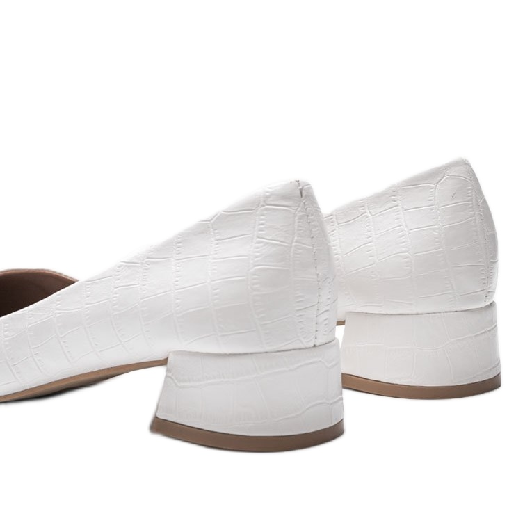 White pumps on a brick in Hallie's snake skin pattern 1