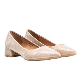 Beige pumps on a brick in the Hallie snake skin pattern 1