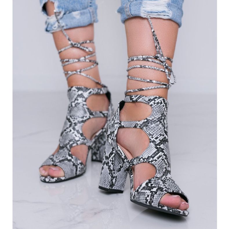 Black sandals on a post in the Gold Jungle snake skin pattern 1