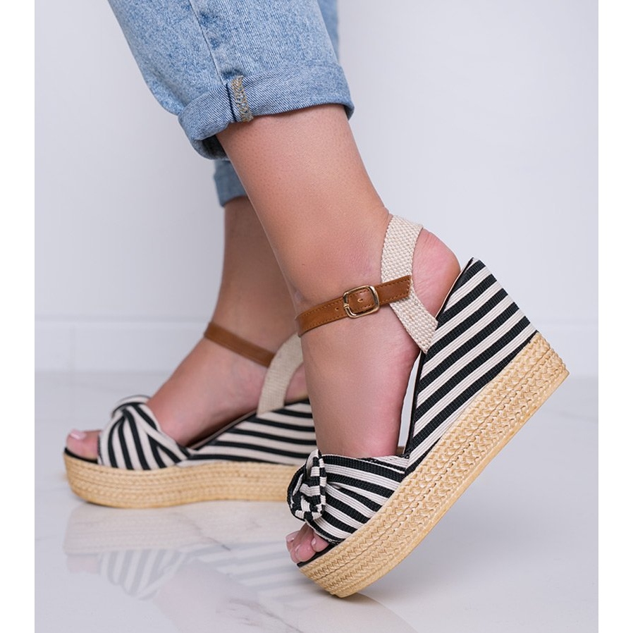 Black and white wedge sandals with a Holiday Vibes bow