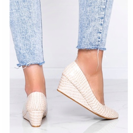 Beige pumps in a crocodile skin pattern on the Wildlife wedge heel 1