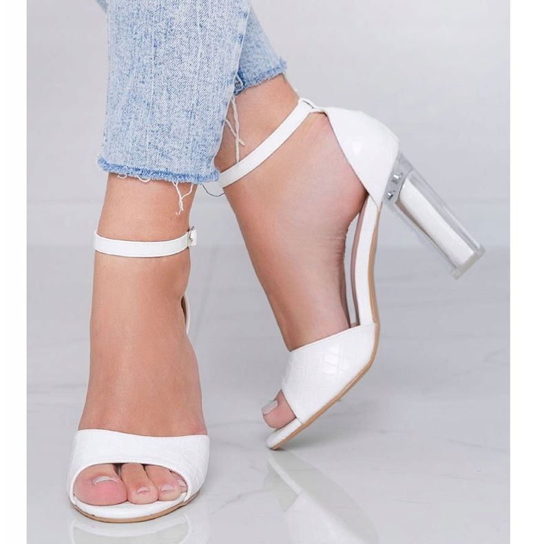 White pumps on a post with a transparent No Fear heel 1