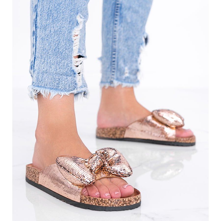 Rose gold slippers with a Norris bow golden