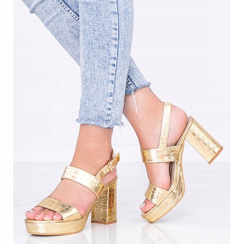 Golden metallic sandals on a post in the Liv animal theme 1
