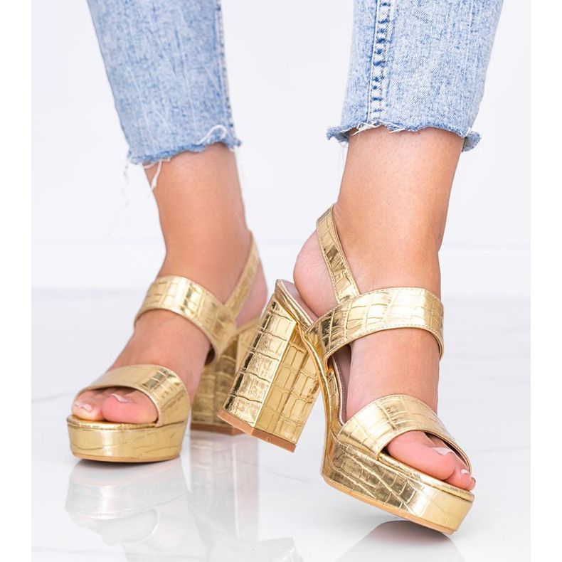 Golden metallic sandals on a post in the Liv animal theme 2