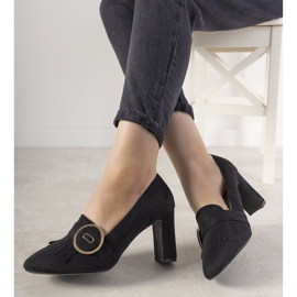 Black pumps on a post with a Promise buckle 2