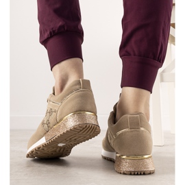 Beige sneakers with golden Moves accessories 1