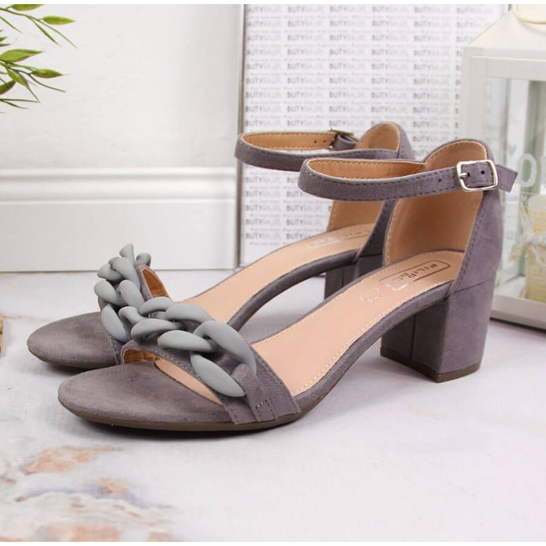 Gray Sandals on a post with a chain W Filippo 2