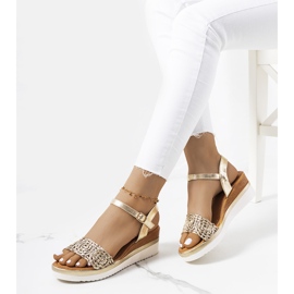 Golden sandals with a decorative Kirk strap 1
