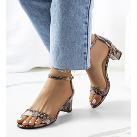 Beige sandals on a post with Azevedo snake motif 1