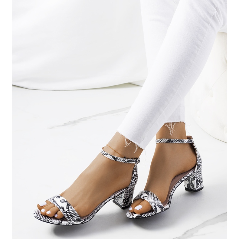 White sandals on a post with the Azevedo snake motif 1