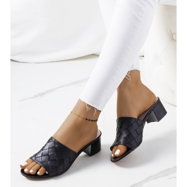 Black woven slippers on the Verdun post 1