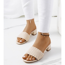 Beige woven slippers on the Verdun post 1